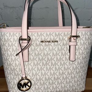 Michael Kors small handbag with adjustable strap.